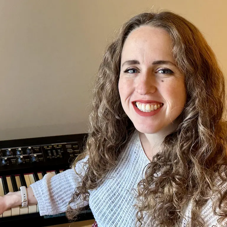 Piano teacher in front of electronic piano keyboard